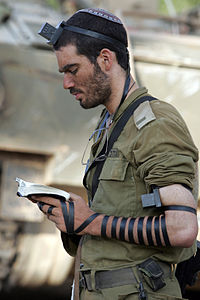 Soldier praying with Tefillin
